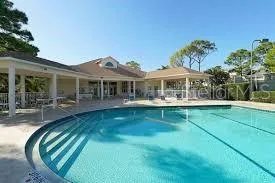 a view of house with a garden and swimming pool