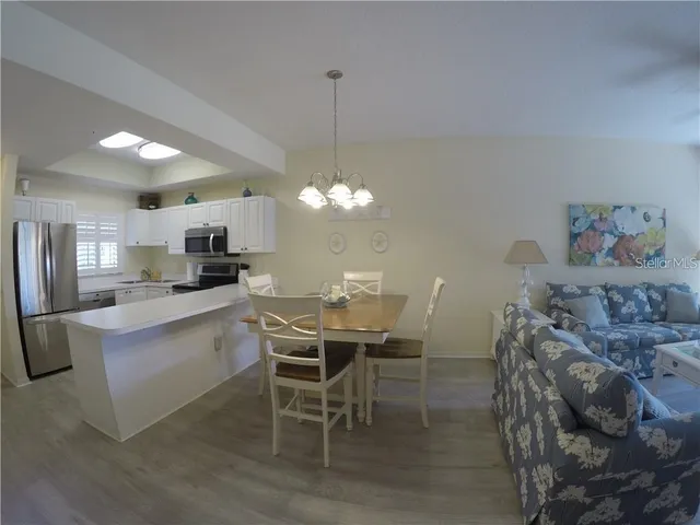 a view of a dining room with furniture and chandelier