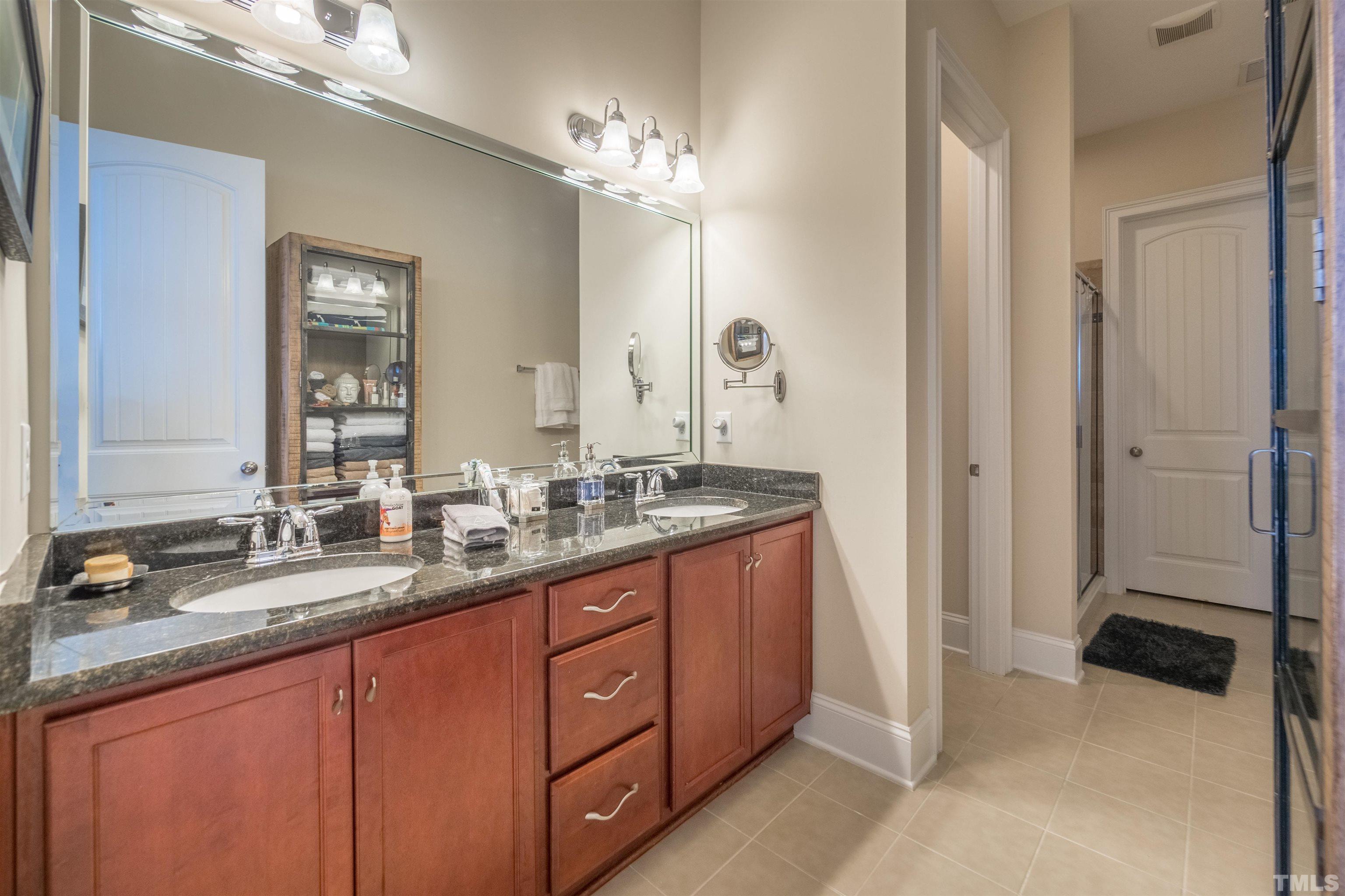 789 Fallon Grove Way Raleigh, NC 27608 - Photo 14 of 29 a bathroom with a double vanity sink and a mirror