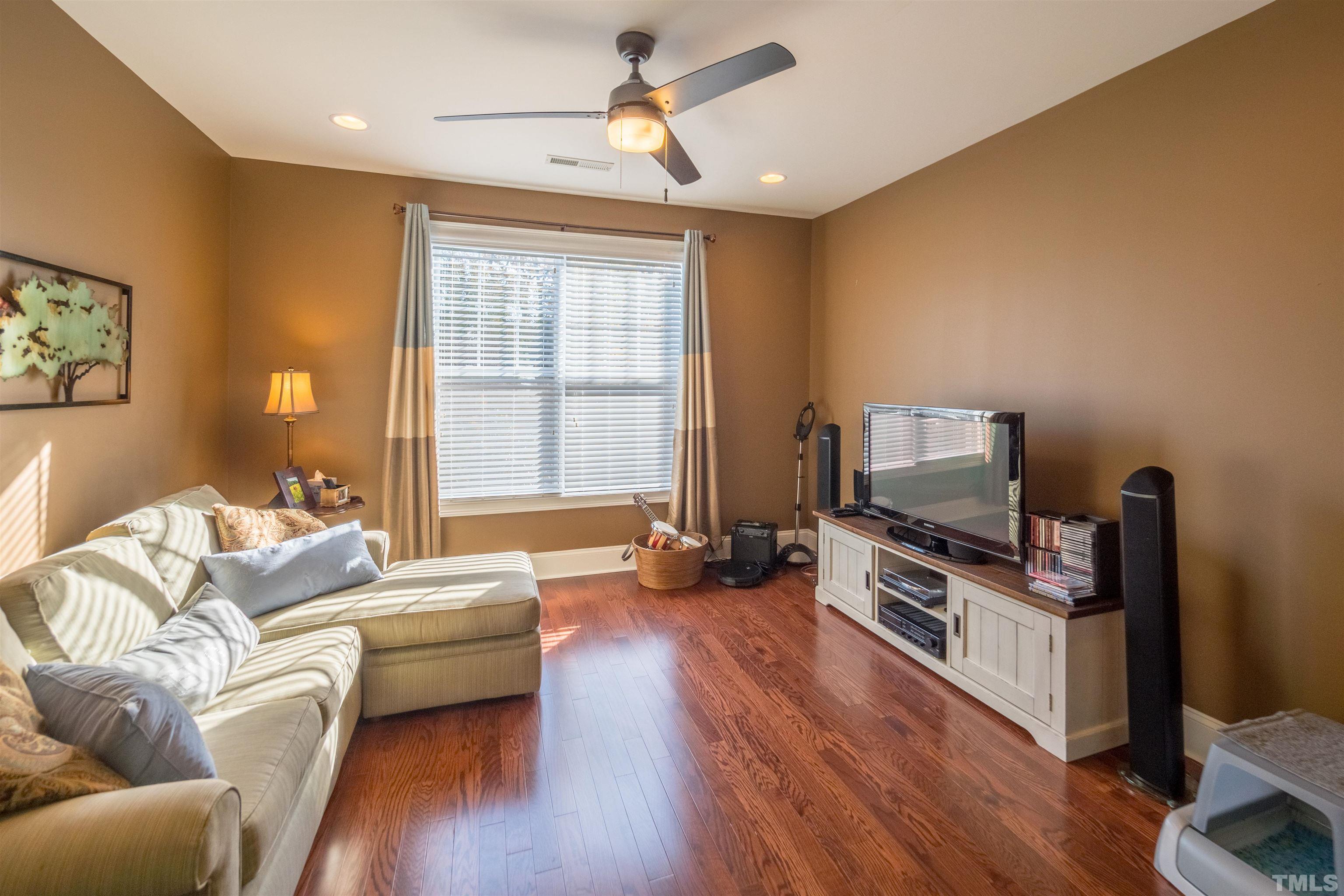 789 Fallon Grove Way Raleigh, NC 27608 - Photo 21 of 29 a living room with furniture a flat screen tv and wooden floor