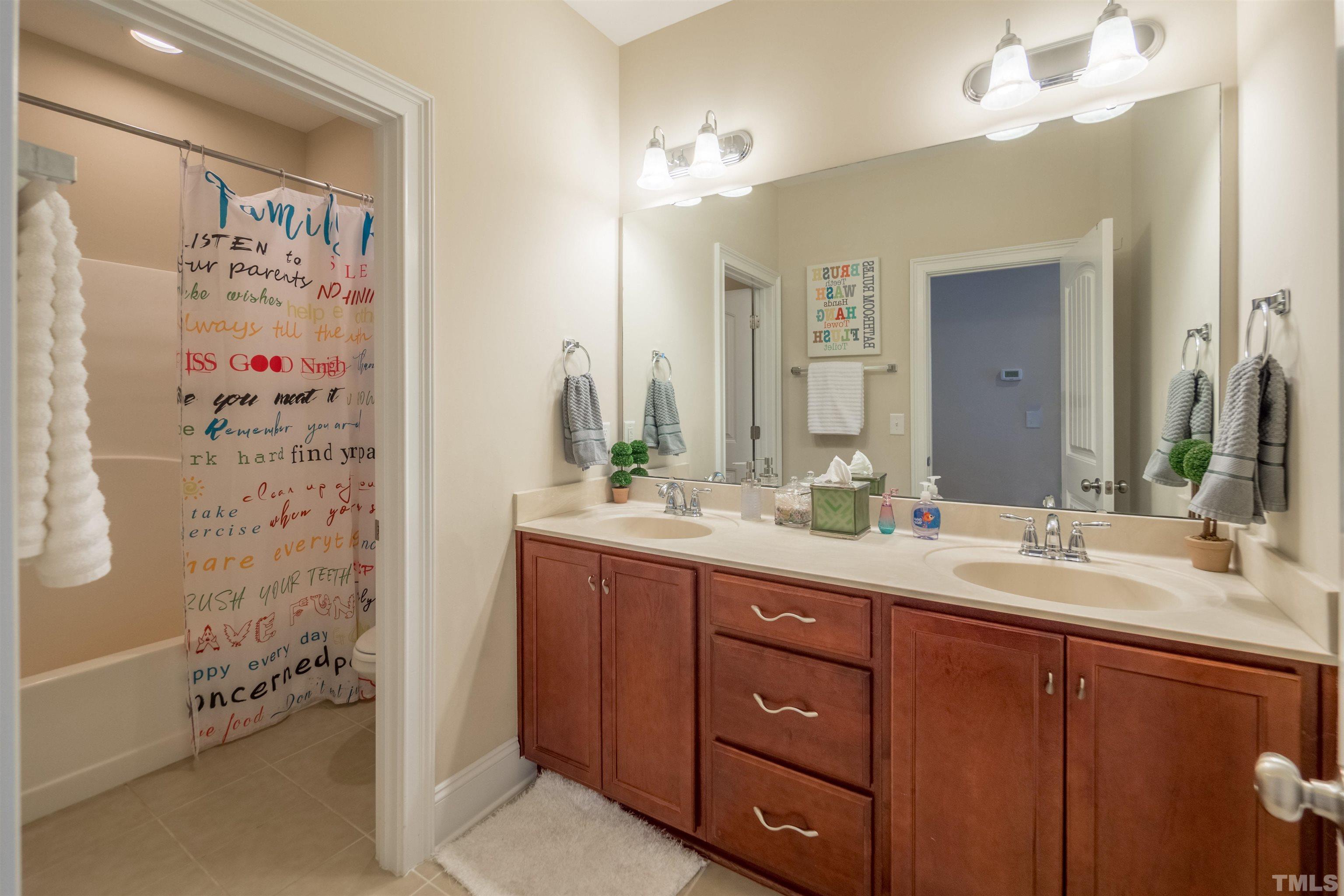 789 Fallon Grove Way Raleigh, NC 27608 - Photo 23 of 29 a bathroom with a double vanity sink mirror and shower