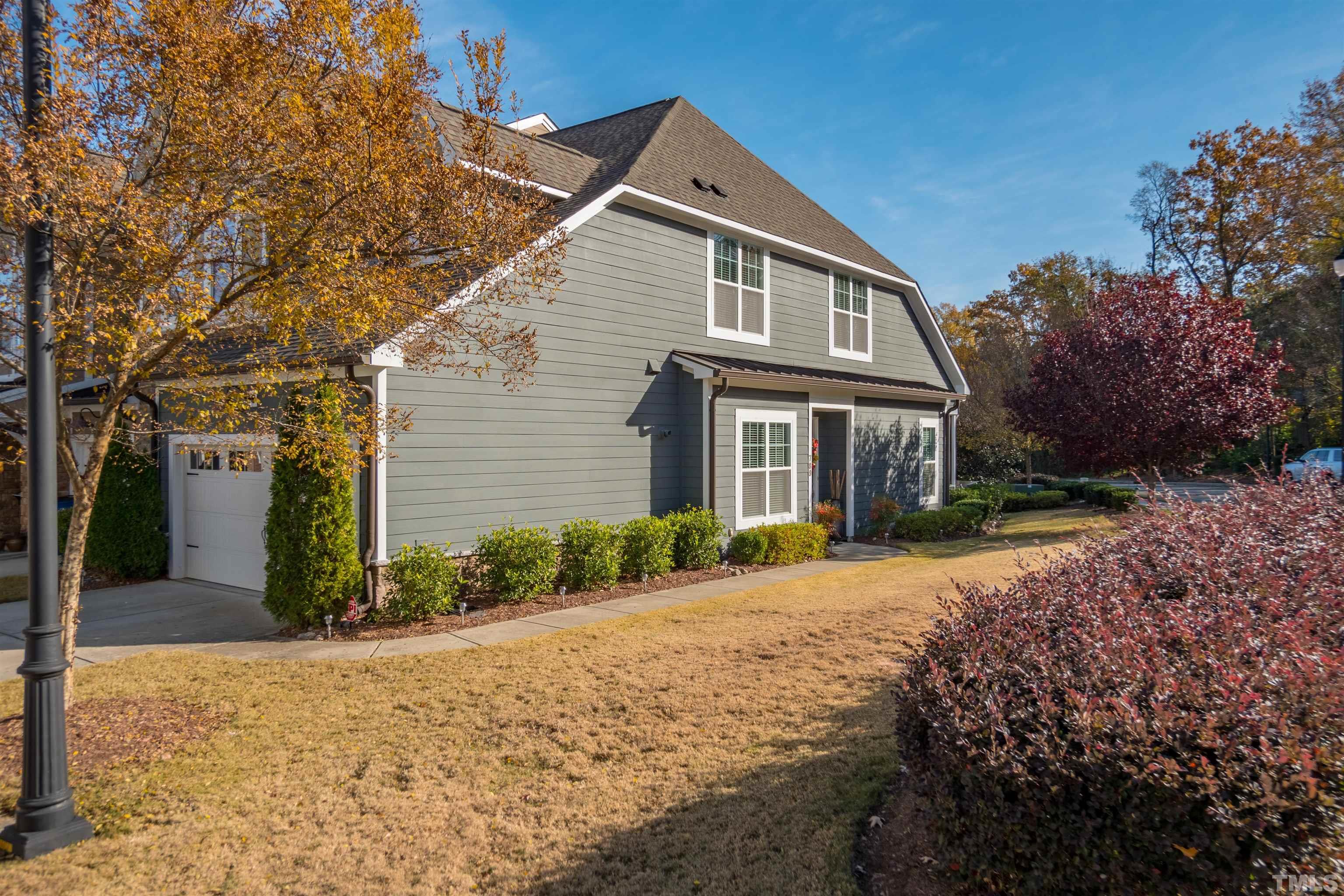 789 Fallon Grove Way Raleigh, NC 27608 - Photo 27 of 29 a front view of a house with a yard and garage