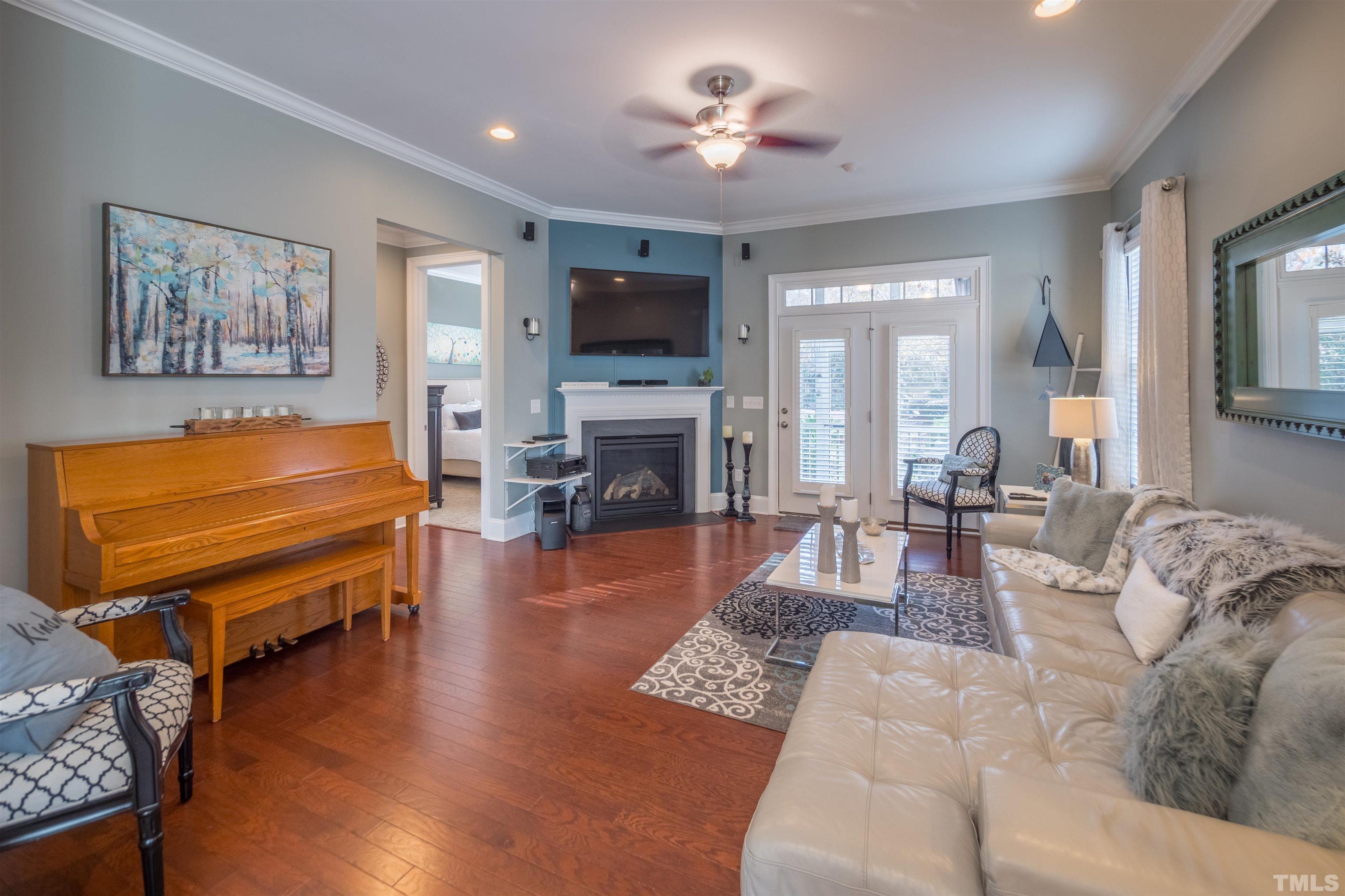 789 Fallon Grove Way Raleigh, NC 27608 - Photo 4 of 29 a living room with furniture a flat screen tv and a fireplace