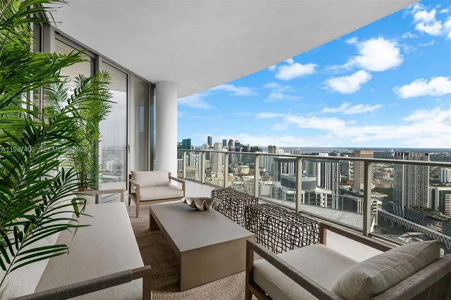 a view of balcony with couch and chairs