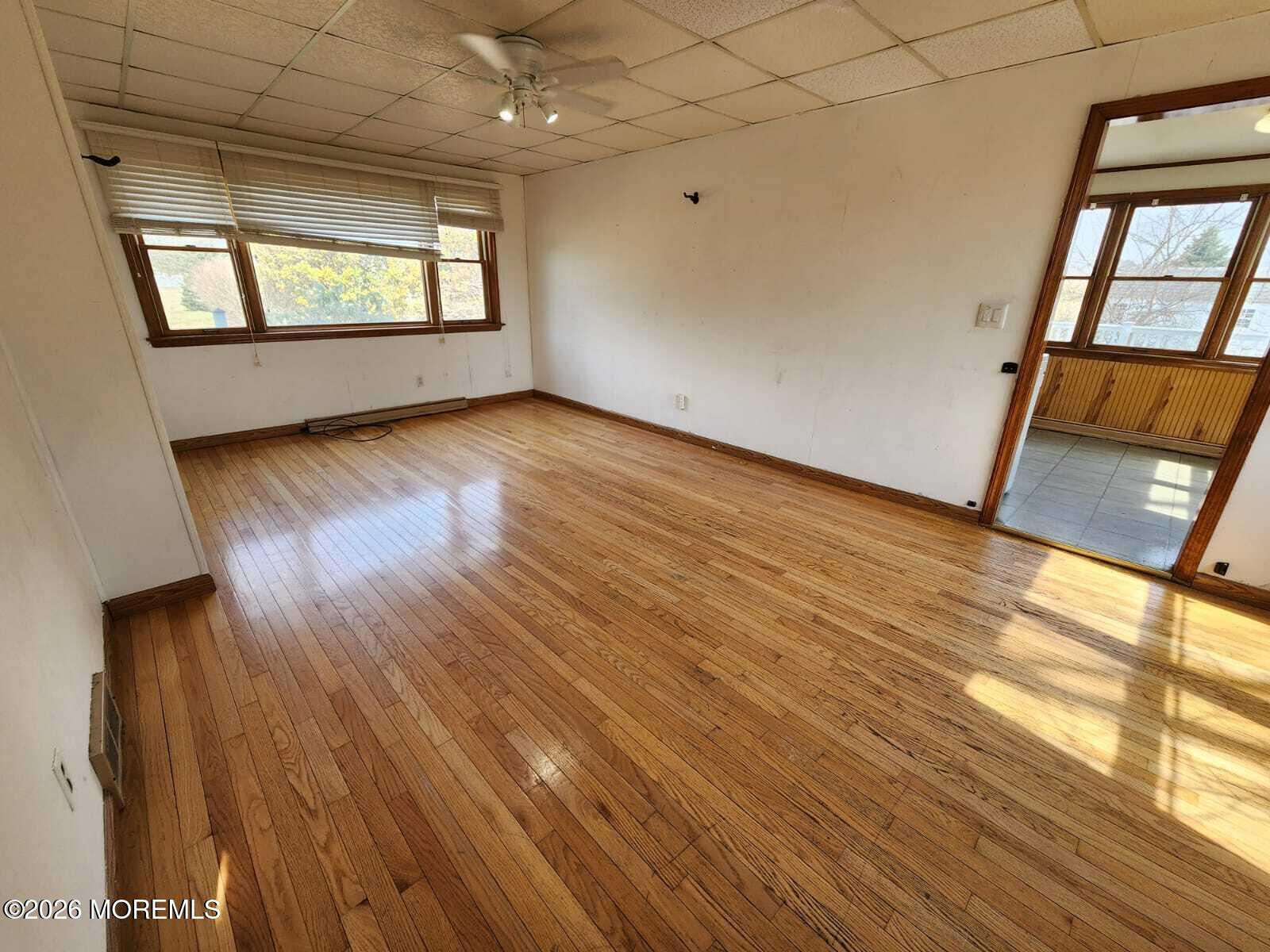 175 Grawtown Road Jackson, NJ 08527 - Photo 13 of 27 an empty room with wooden floor and windows
