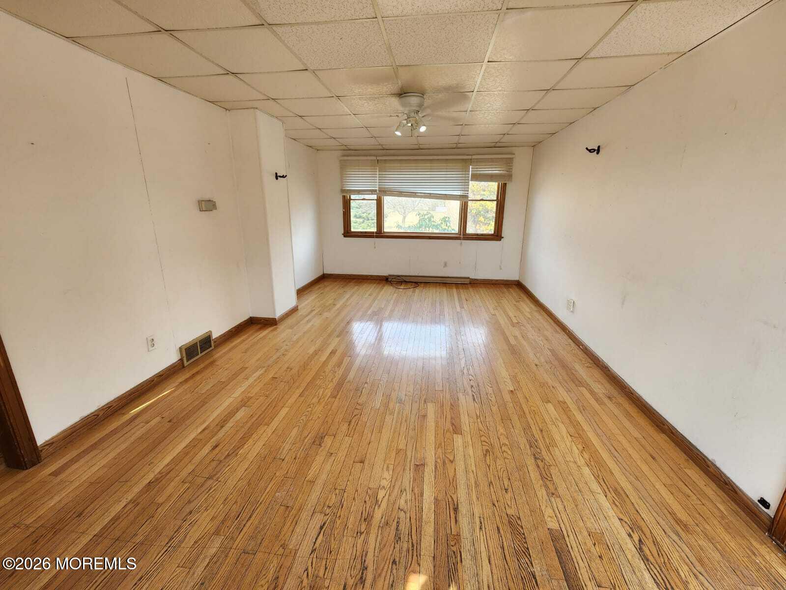 175 Grawtown Road Jackson, NJ 08527 - Photo 14 of 27 a view of empty room with wooden floor and fan