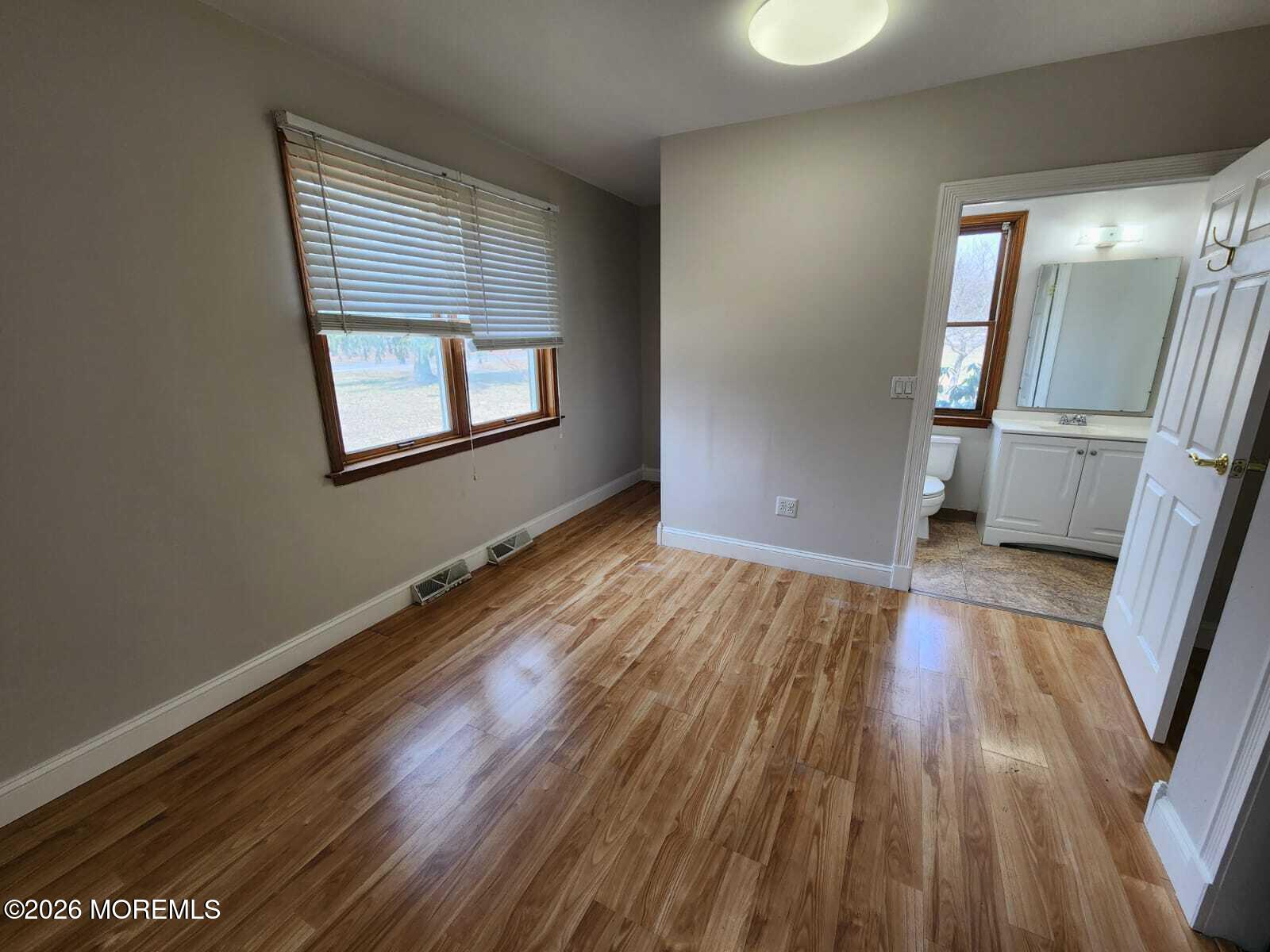 175 Grawtown Road Jackson, NJ 08527 - Photo 10 of 27 wooden floor in an empty room with a window