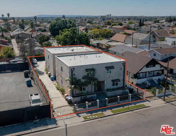 an aerial view of a house with a city street