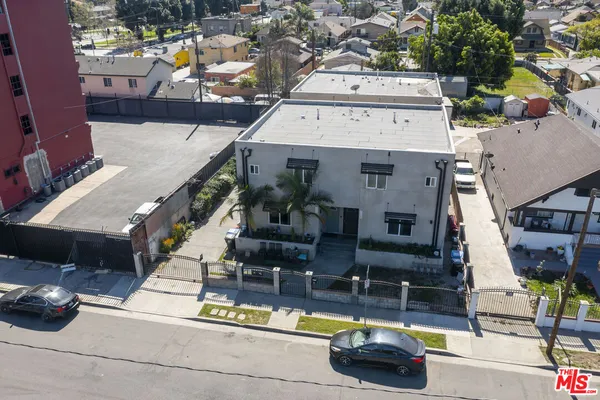 an aerial view of a house with swimming pool and outdoor seating