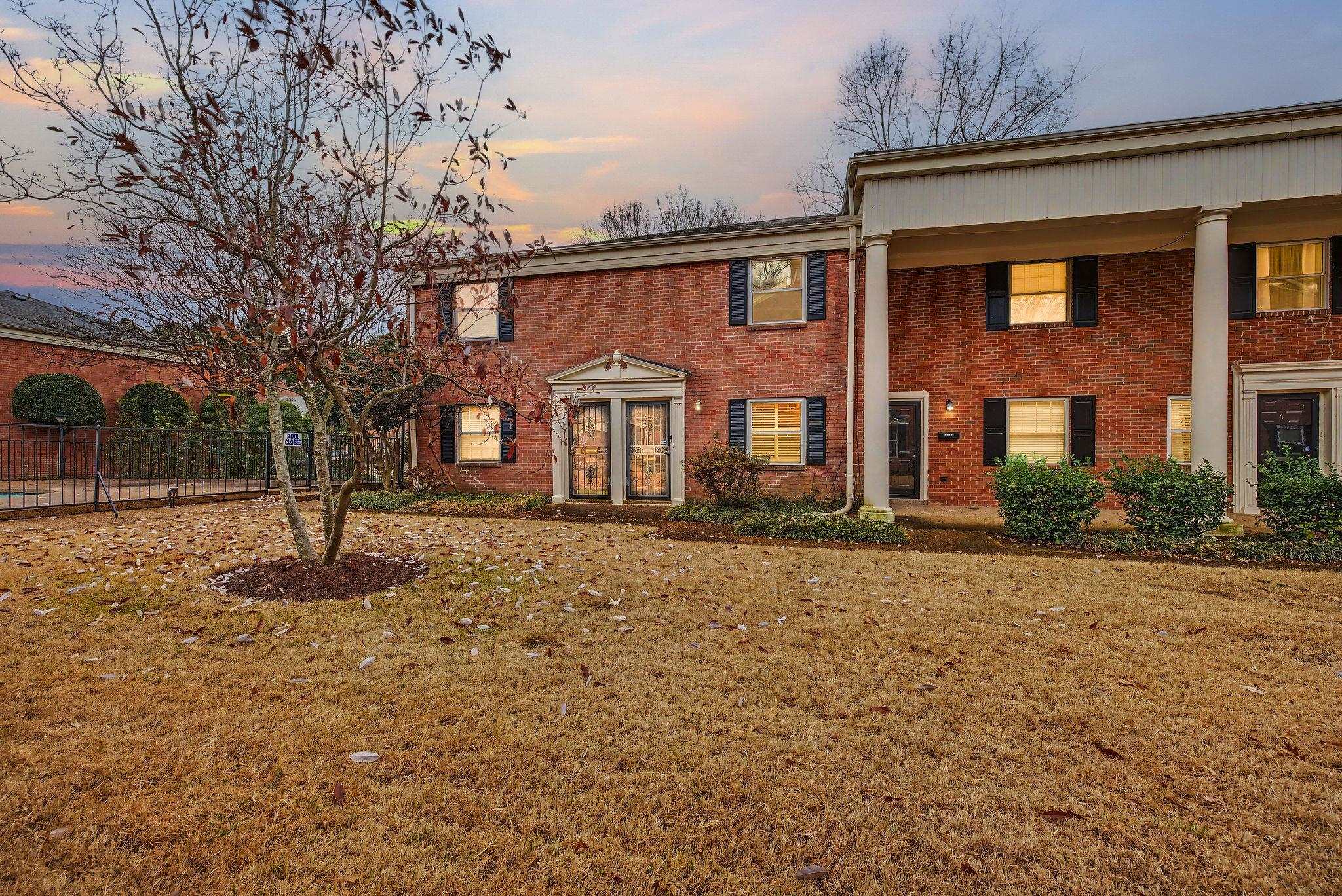View of front of home with brick siding and a porch