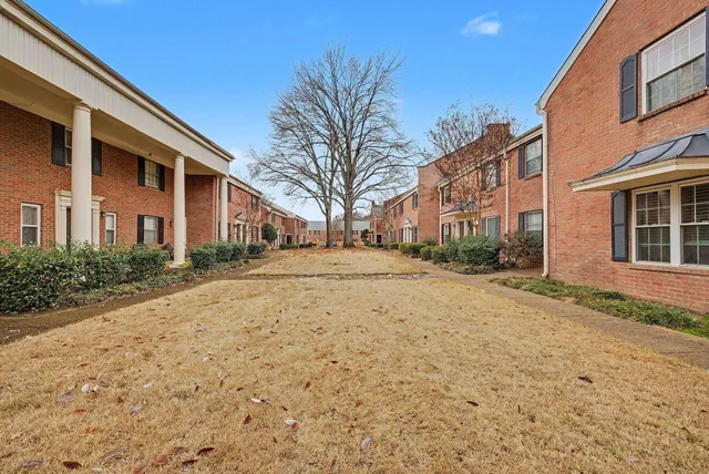 a pathway of a house with a yard