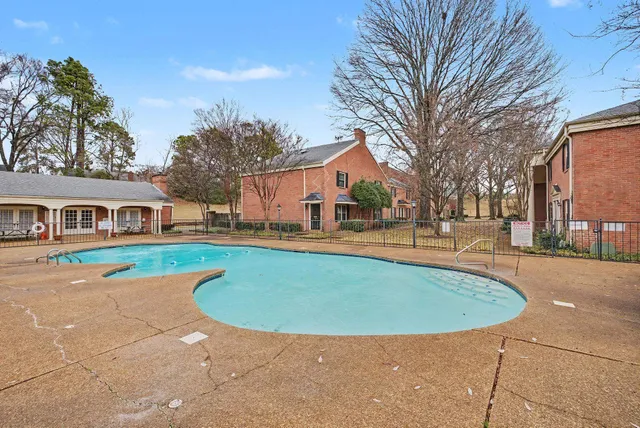 a view of a house with swimming pool and a yard