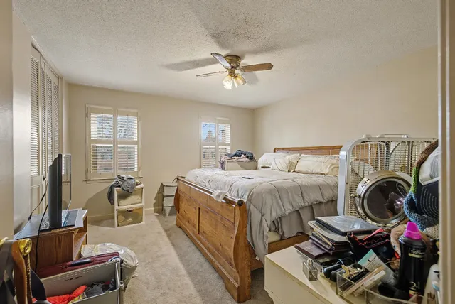 a bedroom with a bed and a chandelier