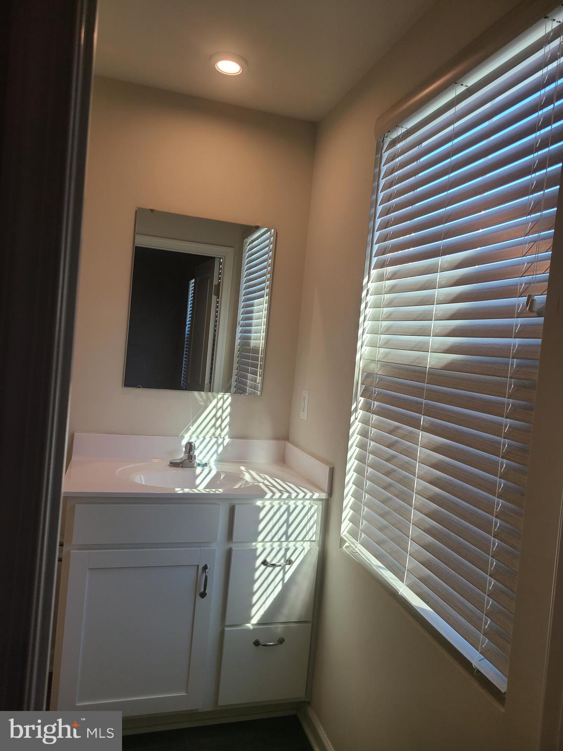 105 Mariners Way Cambridge, MD 21613 - Photo 20 of 45 a bathroom with a sink and a mirror