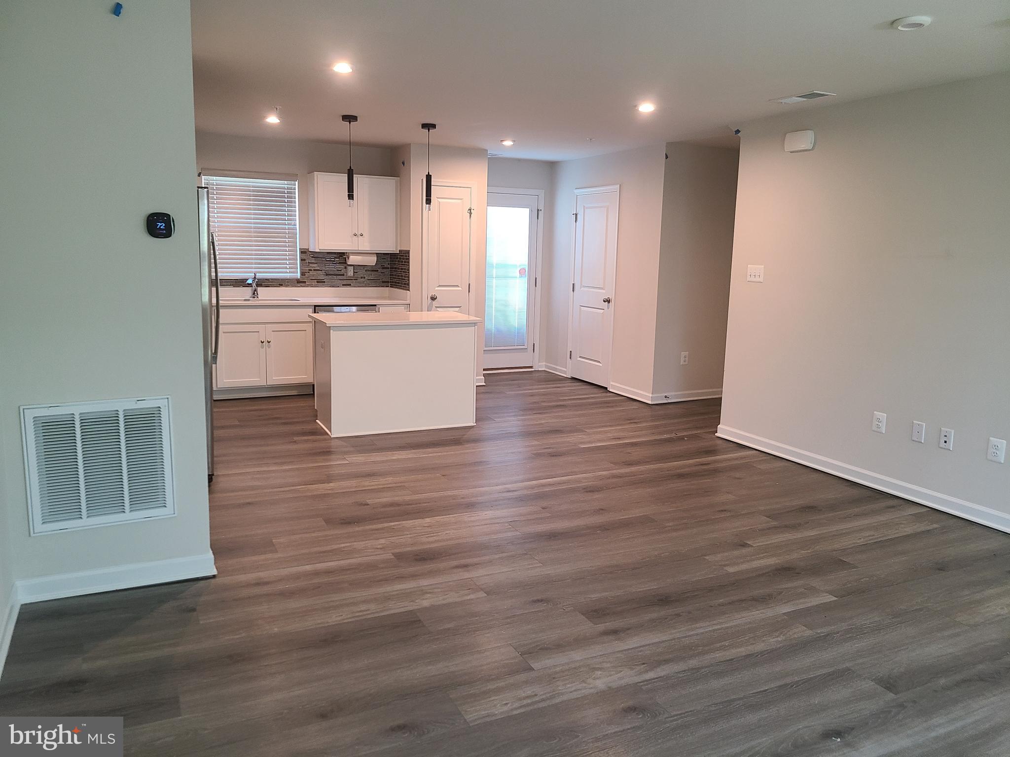 105 Mariners Way Cambridge, MD 21613 - Photo 26 of 45 a large kitchen with stainless steel appliances granite countertop a large counter top and a stove top oven