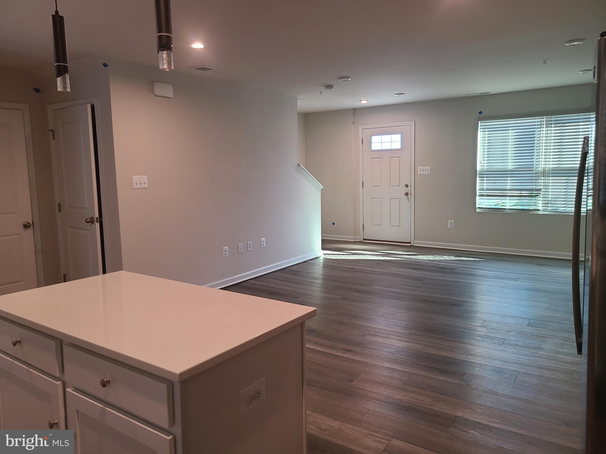 105 Mariners Way Cambridge, MD 21613 - Photo 27 of 45 an empty room with wooden floor and windows