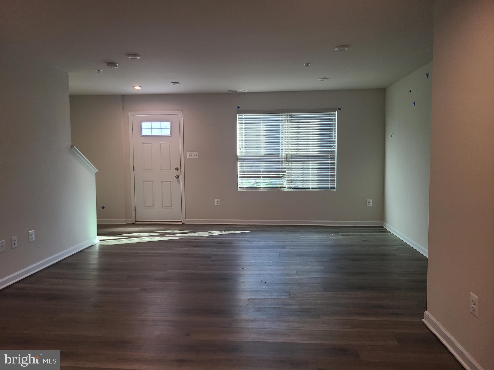 105 Mariners Way Cambridge, MD 21613 - Photo 28 of 45 an empty room with wooden floor and windows