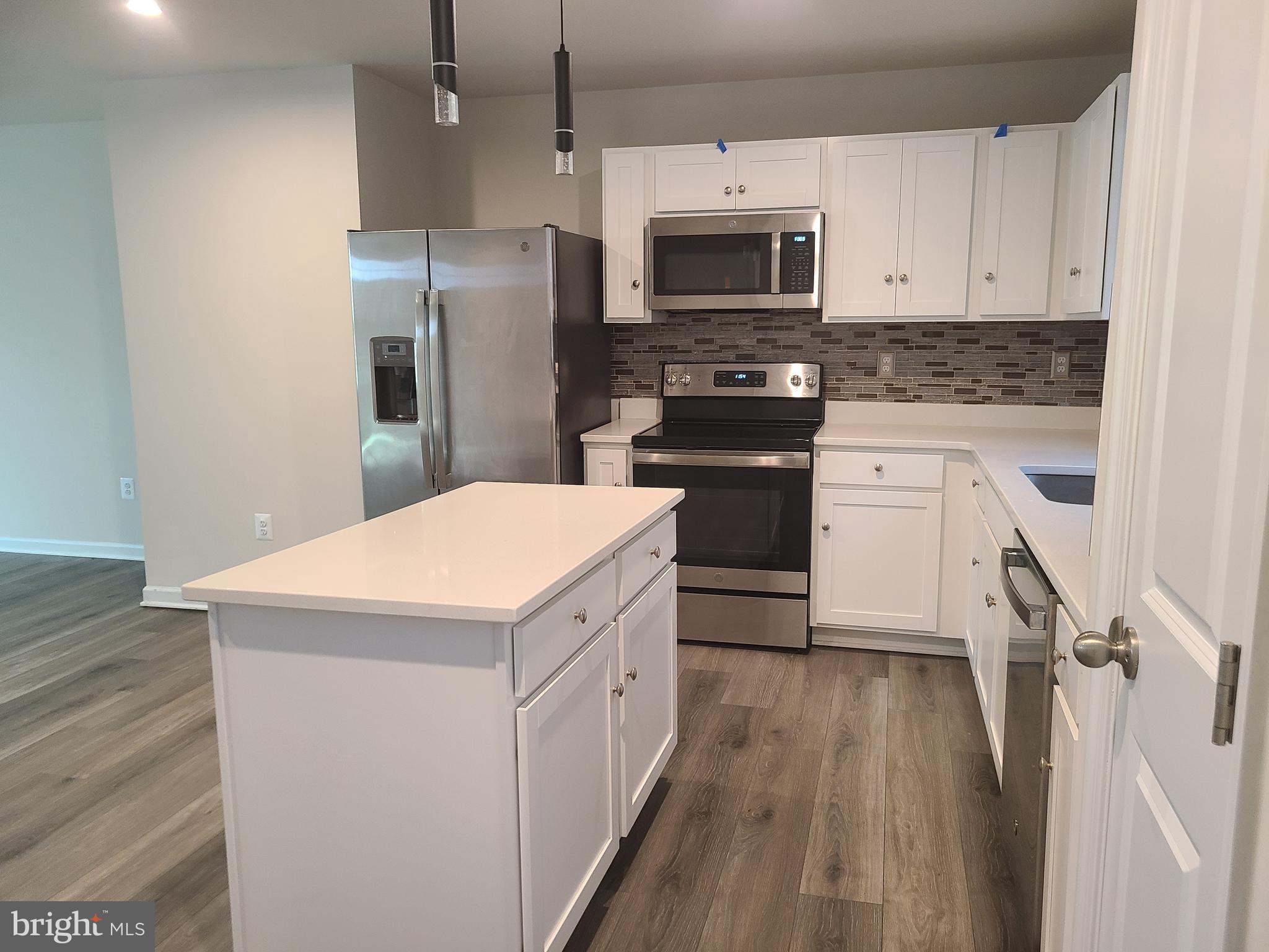 105 Mariners Way Cambridge, MD 21613 - Photo 32 of 45 a kitchen with stainless steel appliances a stove microwave and a refrigerator