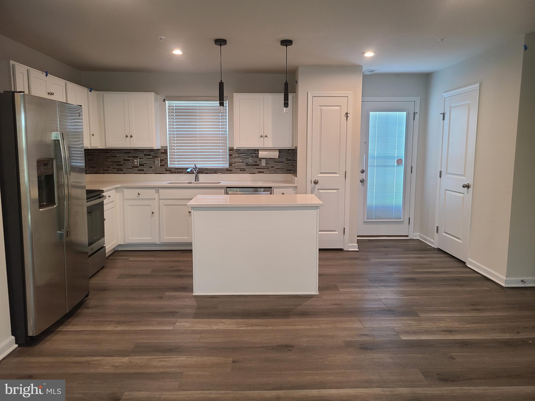 105 Mariners Way Cambridge, MD 21613 - Photo 34 of 45 a kitchen with kitchen island white cabinets and stainless steel appliances