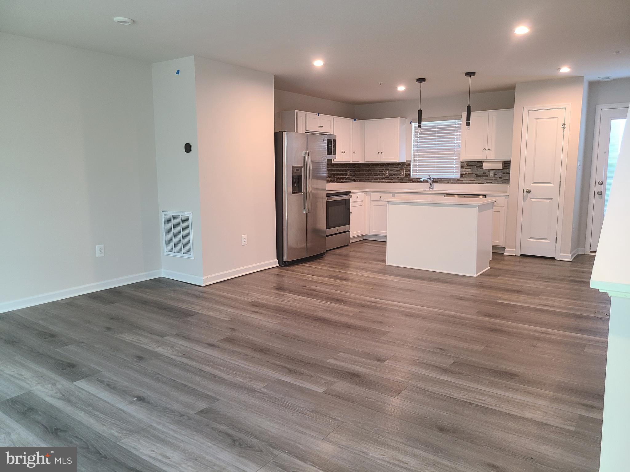 105 Mariners Way Cambridge, MD 21613 - Photo 35 of 45 a view of kitchen with wooden floor and electronic appliances