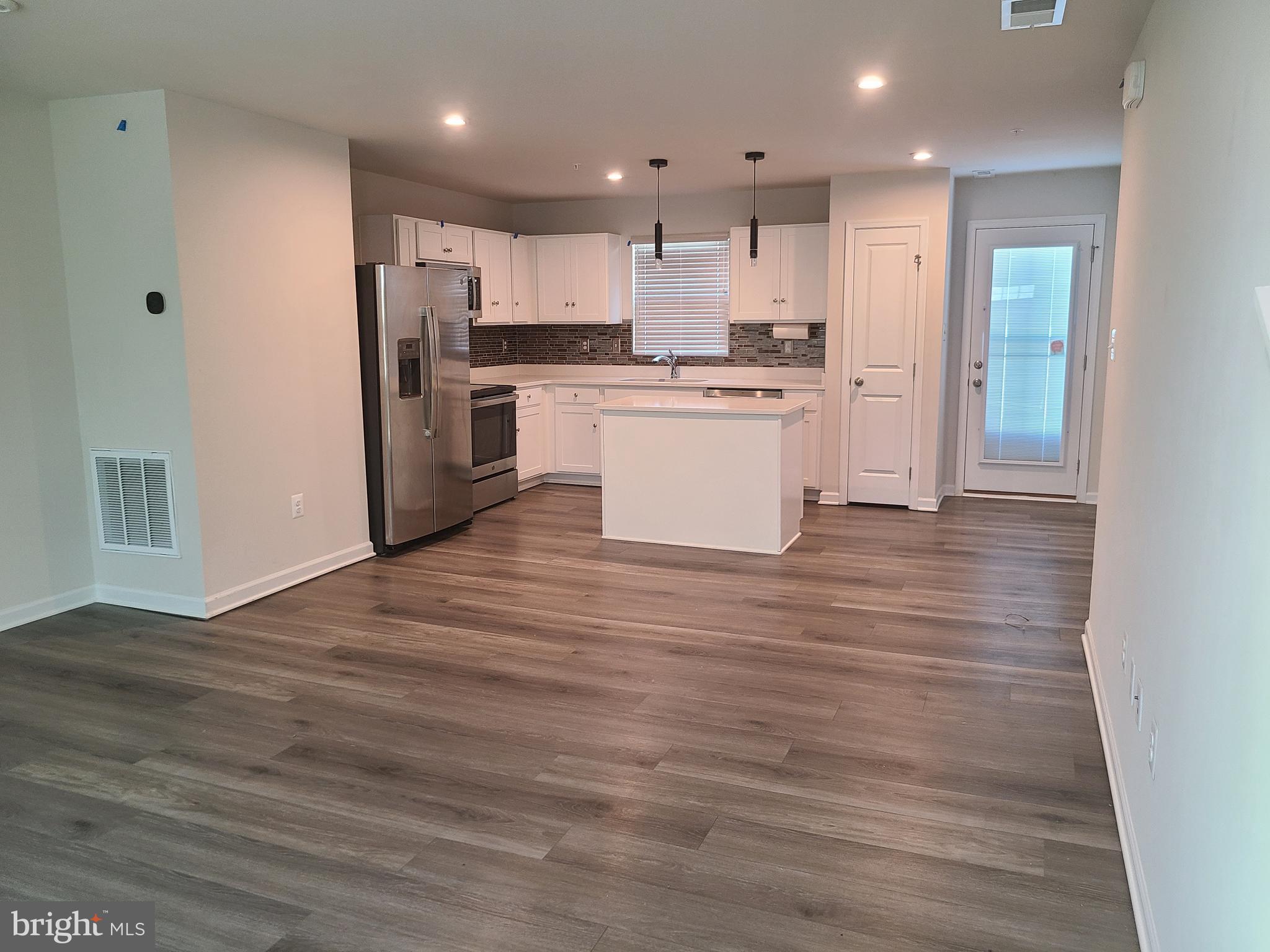 105 Mariners Way Cambridge, MD 21613 - Photo 36 of 45 a view of kitchen with wooden floor and electronic appliances