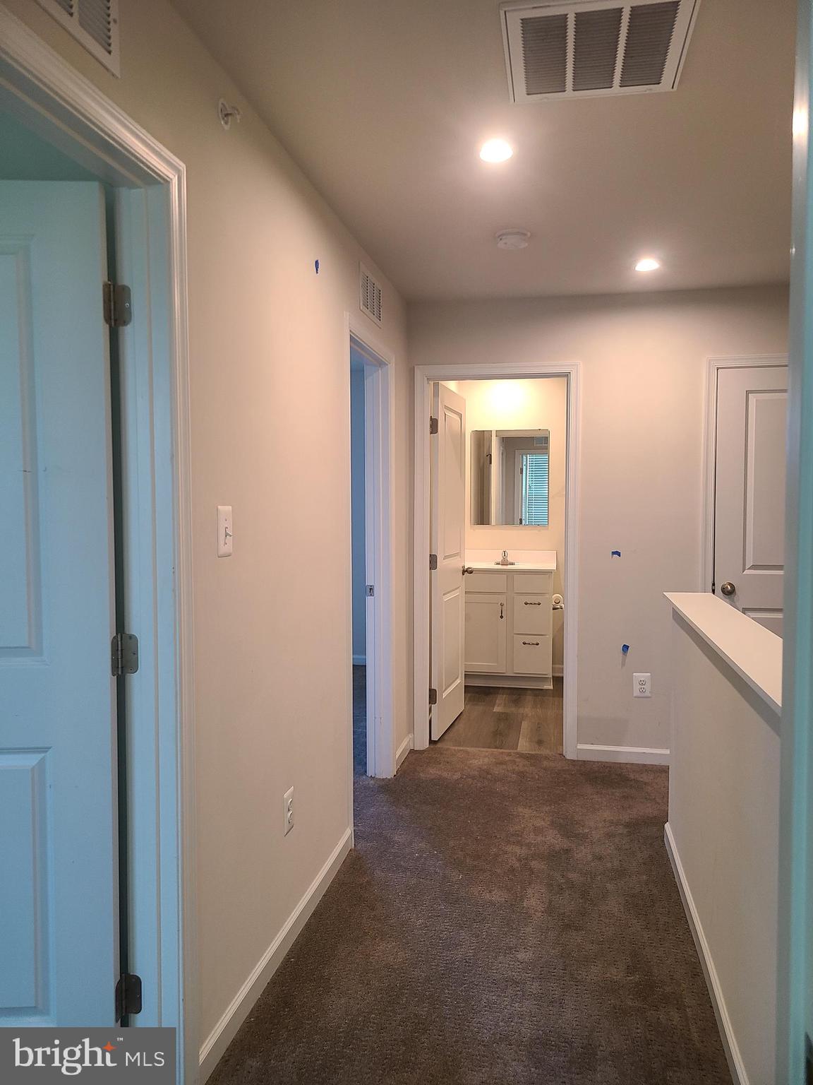 105 Mariners Way Cambridge, MD 21613 - Photo 9 of 45 a view of a hallway with wooden shelves