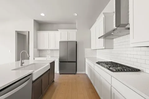 a kitchen with a refrigerator and a sink