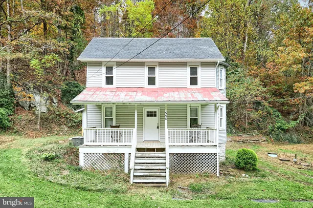 a front view of a house with a yard table and chairs