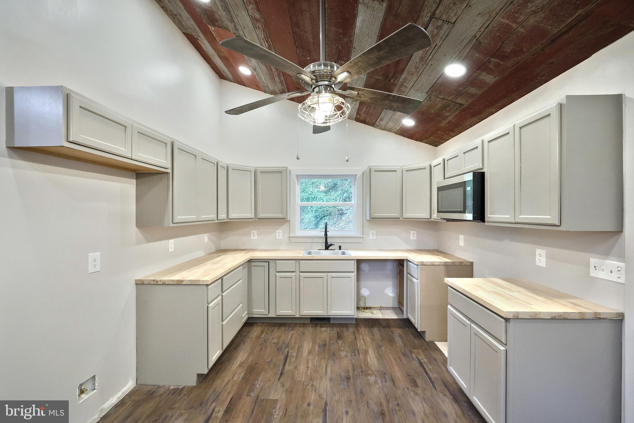 556 Bair Road Delta, PA 17314 - Photo 25 of 48 a kitchen with a sink cabinets stainless steel appliances and a counter top space