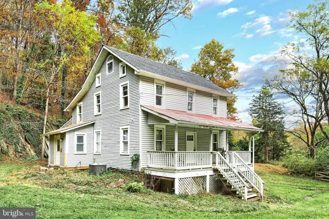 a front view of a house with a yard table and chairs