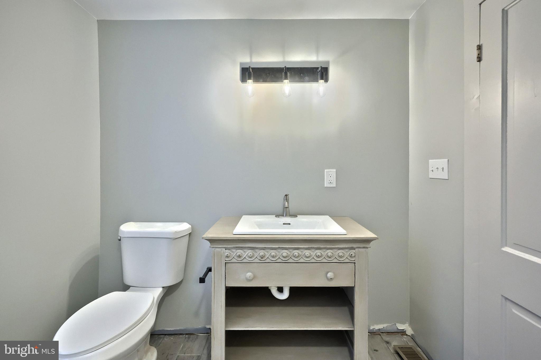 556 Bair Road Delta, PA 17314 - Photo 35 of 48 a bathroom with a sink a toilet and a mirror