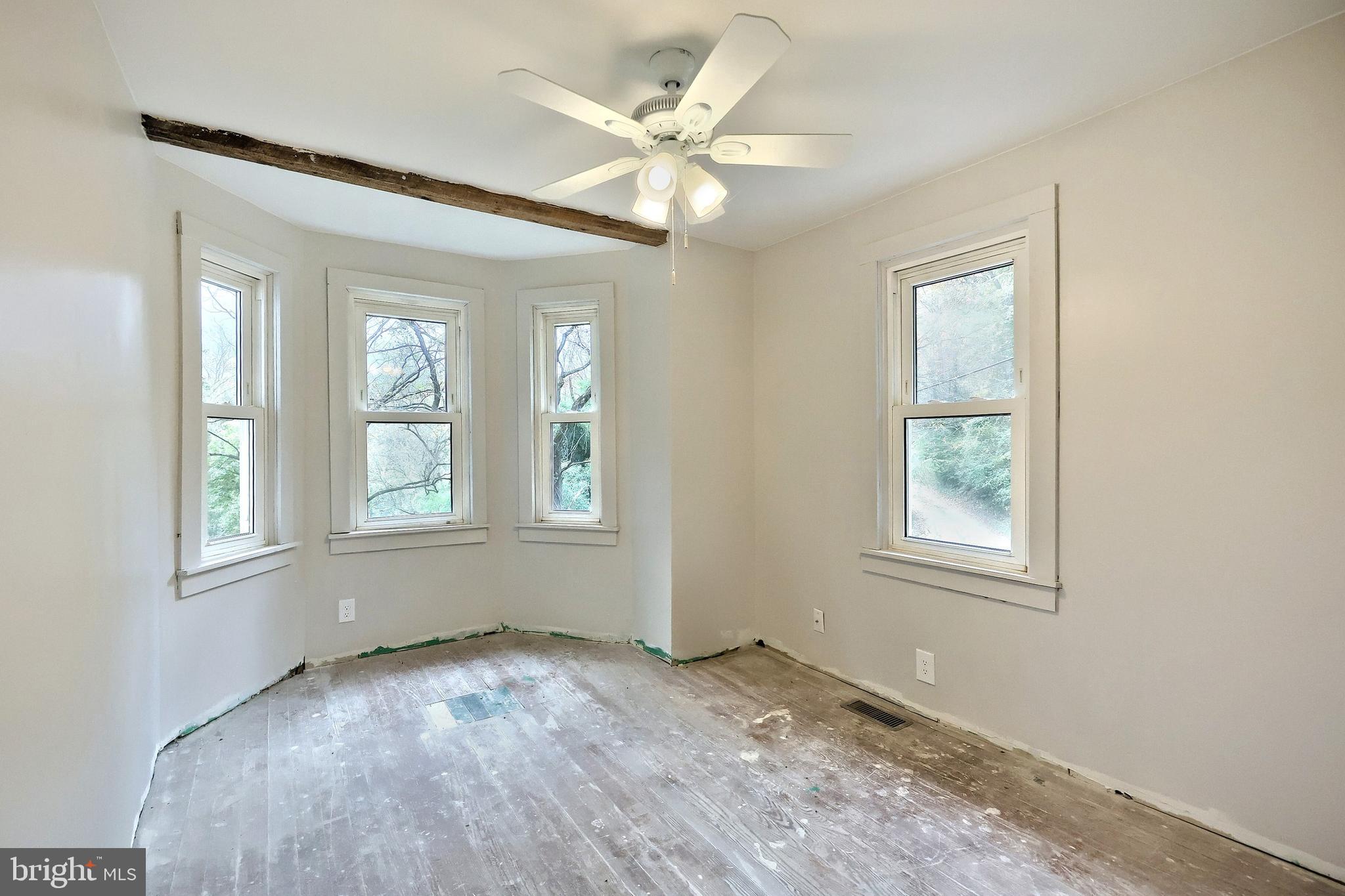 556 Bair Road Delta, PA 17314 - Photo 36 of 48 an empty room with chandelier fan and windows