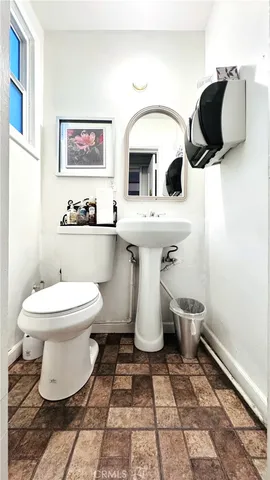 a bathroom with a toilet sink and mirror