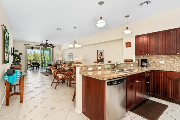 a kitchen with a dining table cabinets and sink