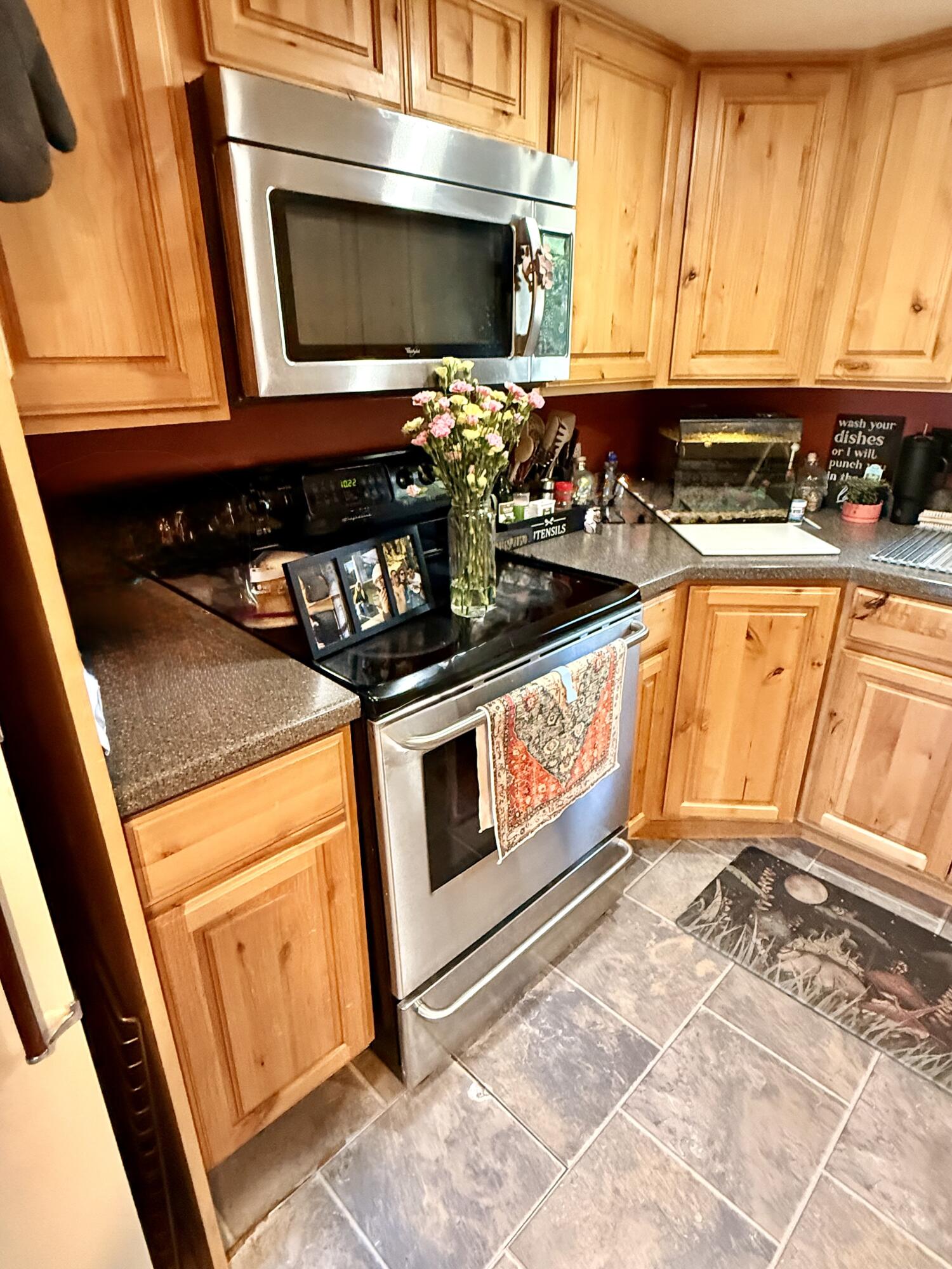 16025 Strawn Road La Pine, OR 97739 - Photo 15 of 70 a kitchen with stainless steel appliances granite countertop a stove a sink and a microwave
