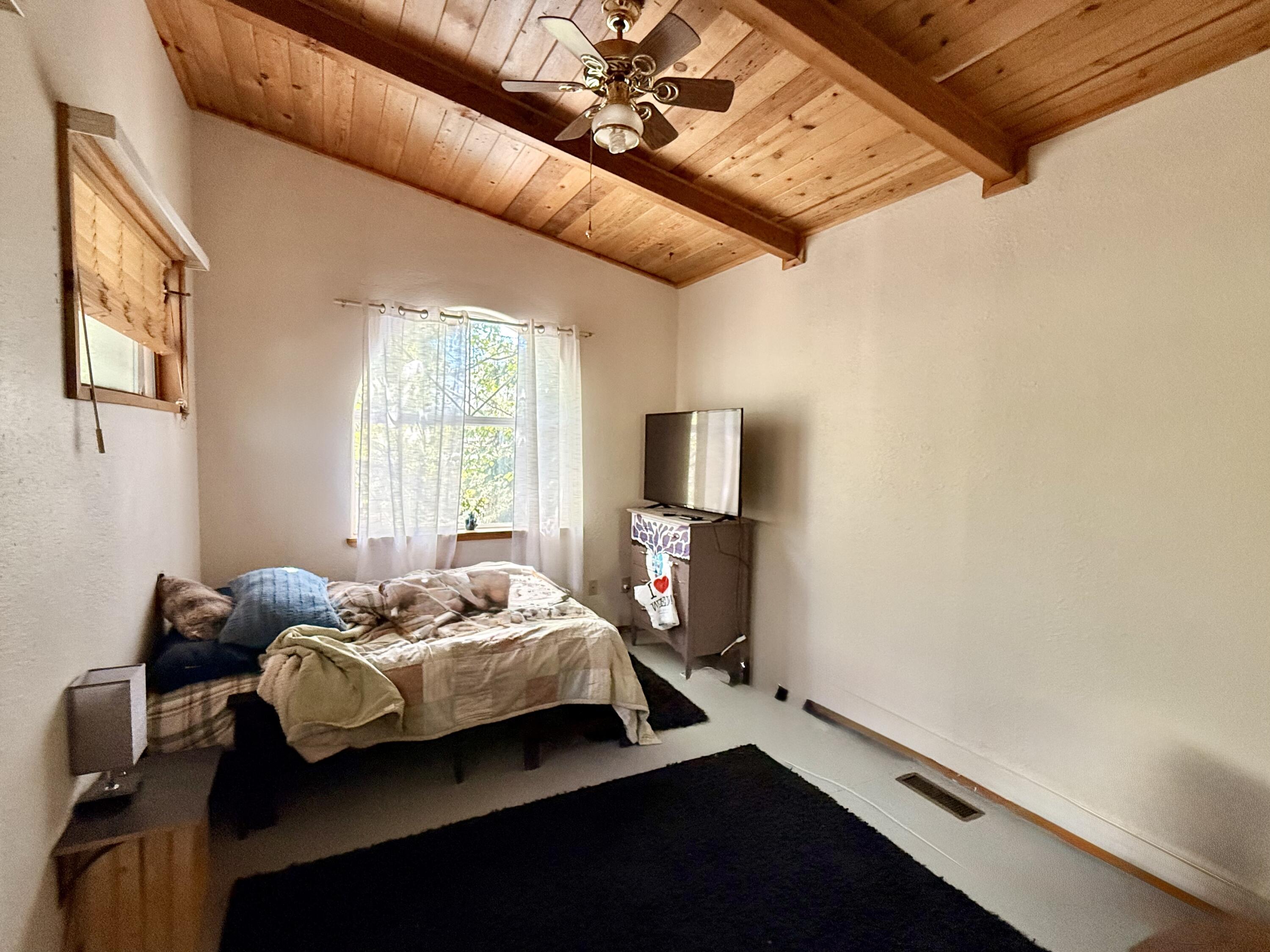 16025 Strawn Road La Pine, OR 97739 - Photo 23 of 70 a bedroom with a bed and wooden floor
