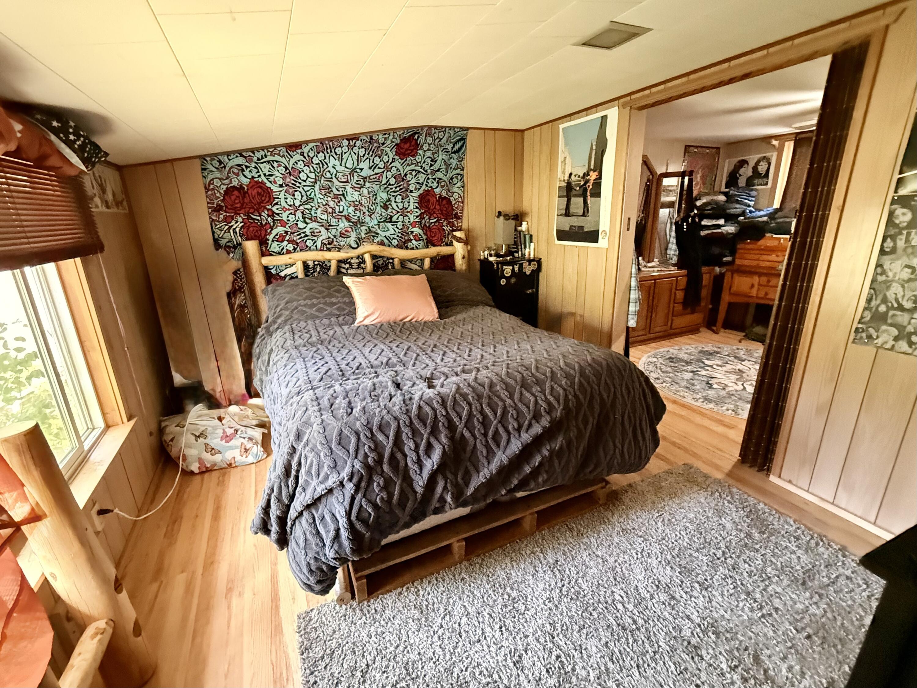 16025 Strawn Road La Pine, OR 97739 - Photo 29 of 70 a bedroom with a bed and wooden floor