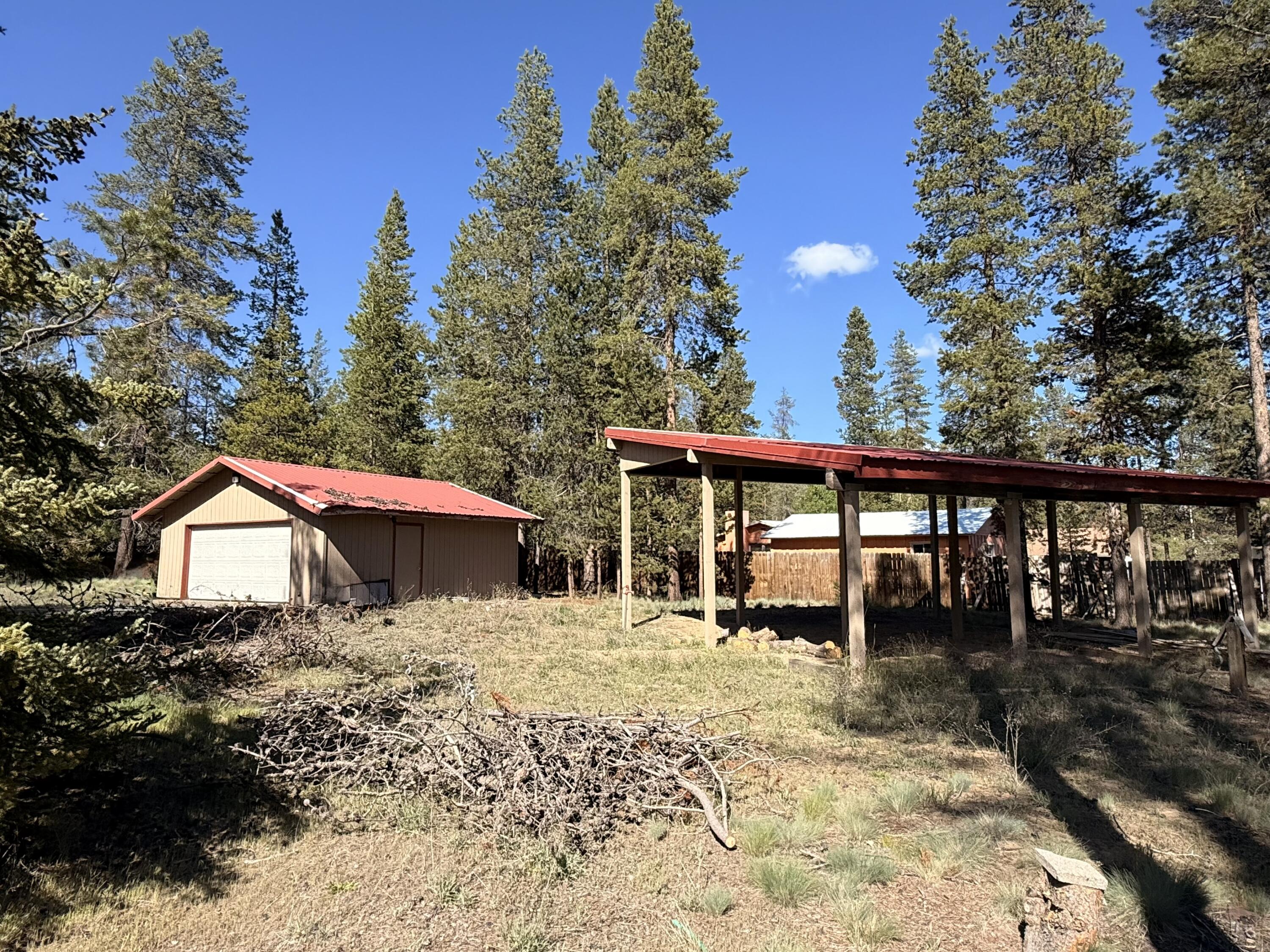 16025 Strawn Road La Pine, OR 97739 - Photo 33 of 70 a backyard of a house with large trees and outdoor seating
