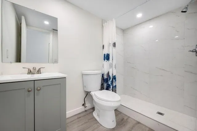 a bathroom with a sink toilet and shower