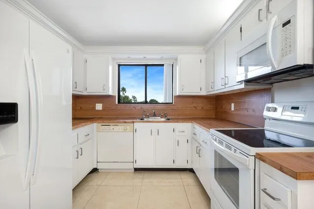 a kitchen with granite countertop cabinets stainless steel appliances and a sink