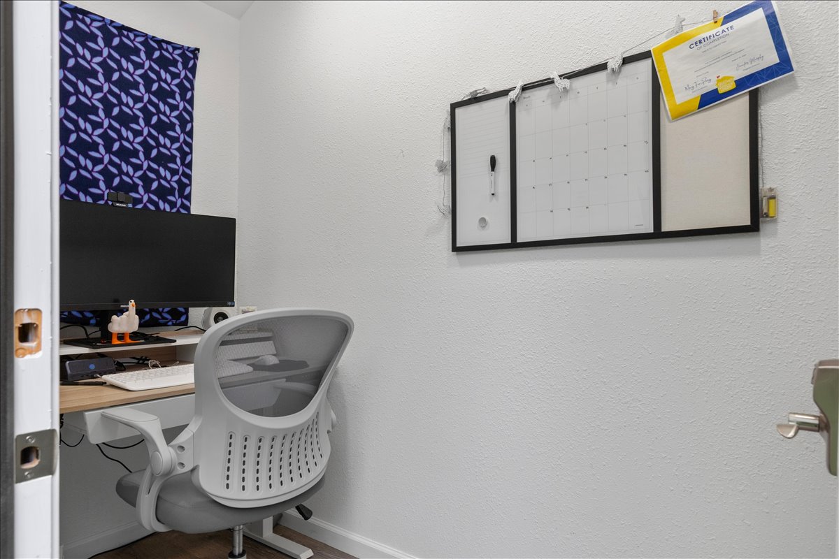 607 Short Street Smithville, TX 78957 - Photo 27 of 31 Dedicated workspace featuring a built-in wood-finish desk and crisp white walls