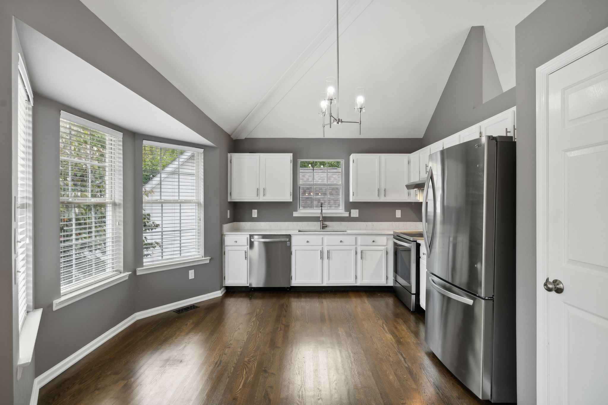 3014 Bent Tree Road Franklin, TN 37067 - Photo 8 of 28 a kitchen with a refrigerator wooden floor a window and a sink