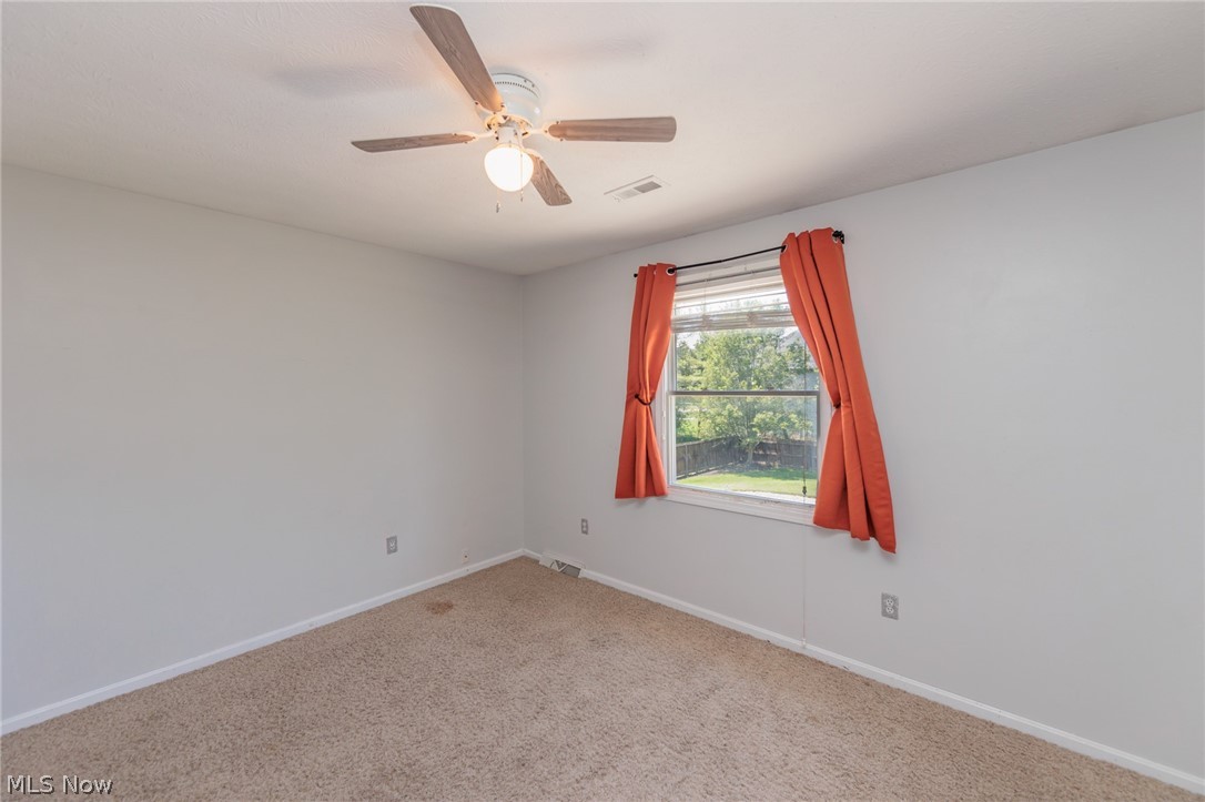 5630 Oak Point Road Lorain, OH 44053 - Photo 29 of 44 Carpeted empty room featuring ceiling fan