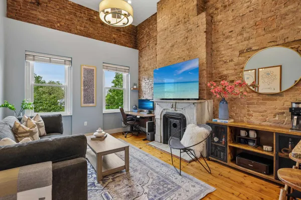 a living room with furniture a rug and a fireplace