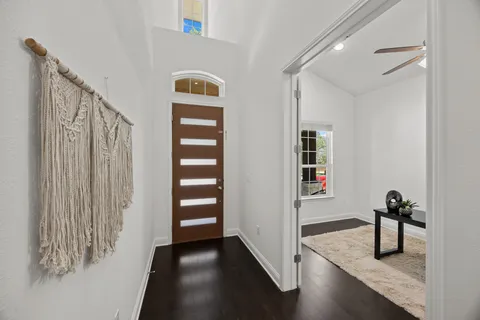 a view of an entryway with wooden floor