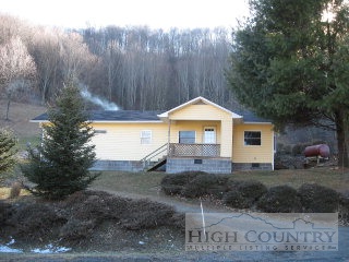489 Joe Weaver Road Lansing, NC 28643 - Photo 1 of 1 a front view of a house with a yard