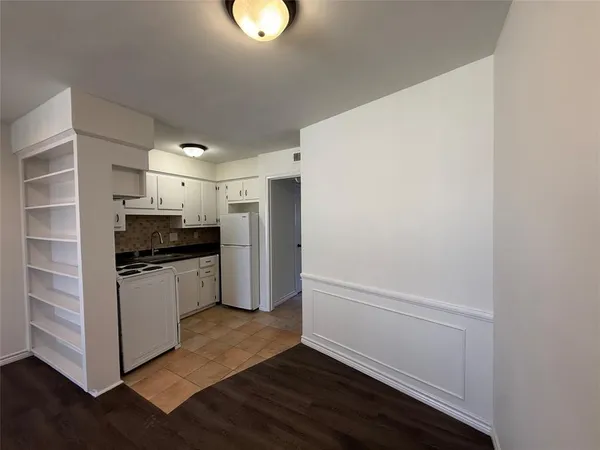 a kitchen with a refrigerator and a stove