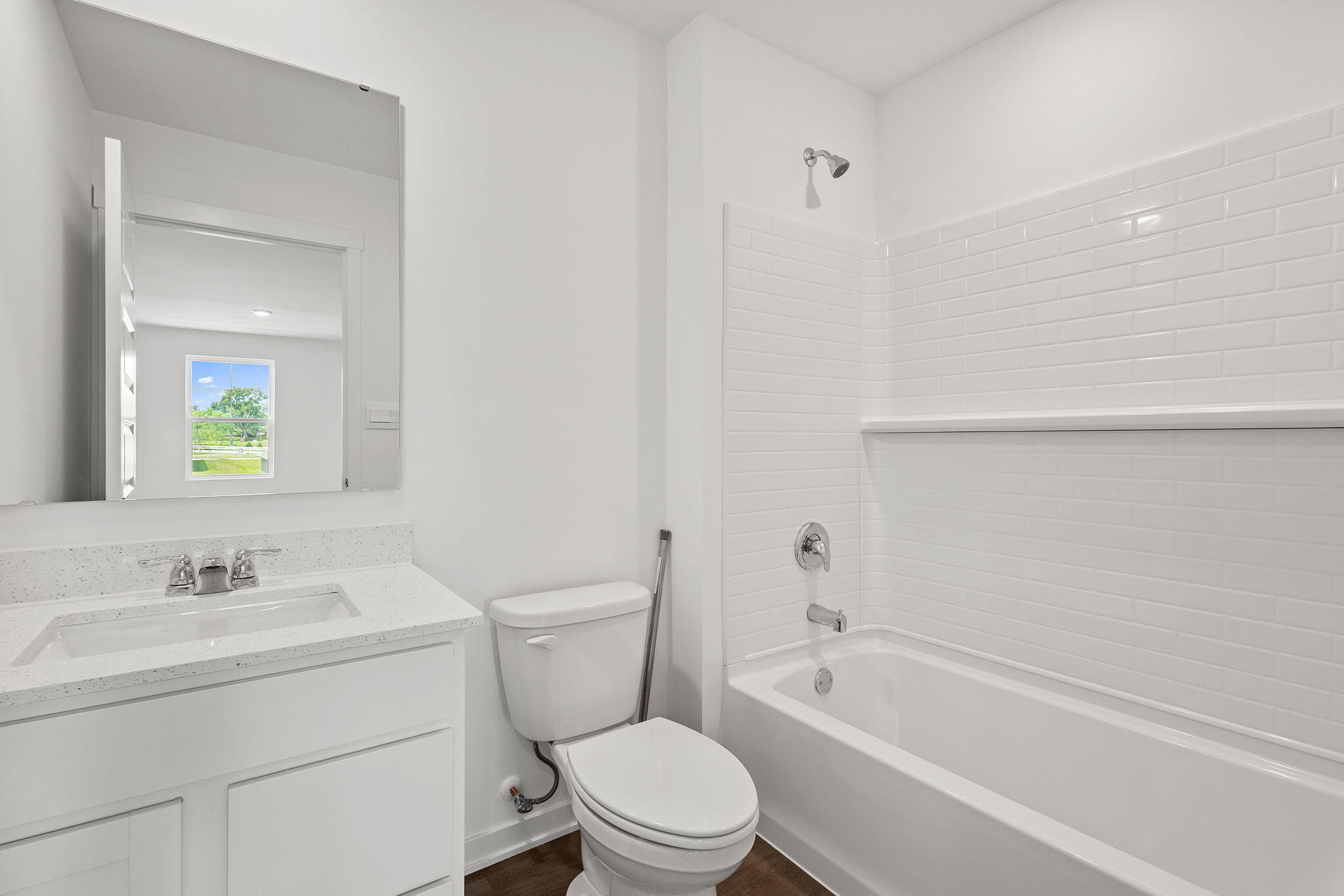 594 Petry Street Hebron, IN 46341 - Photo 15 of 18 a bathroom with a toilet a sink a mirror and bathtub