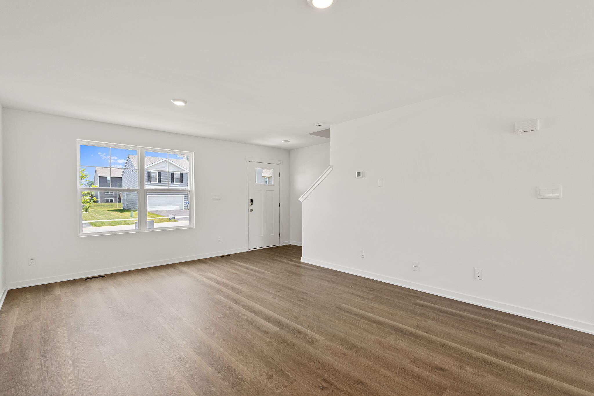 594 Petry Street Hebron, IN 46341 - Photo 5 of 18 a view of an empty room with wooden floor and a window
