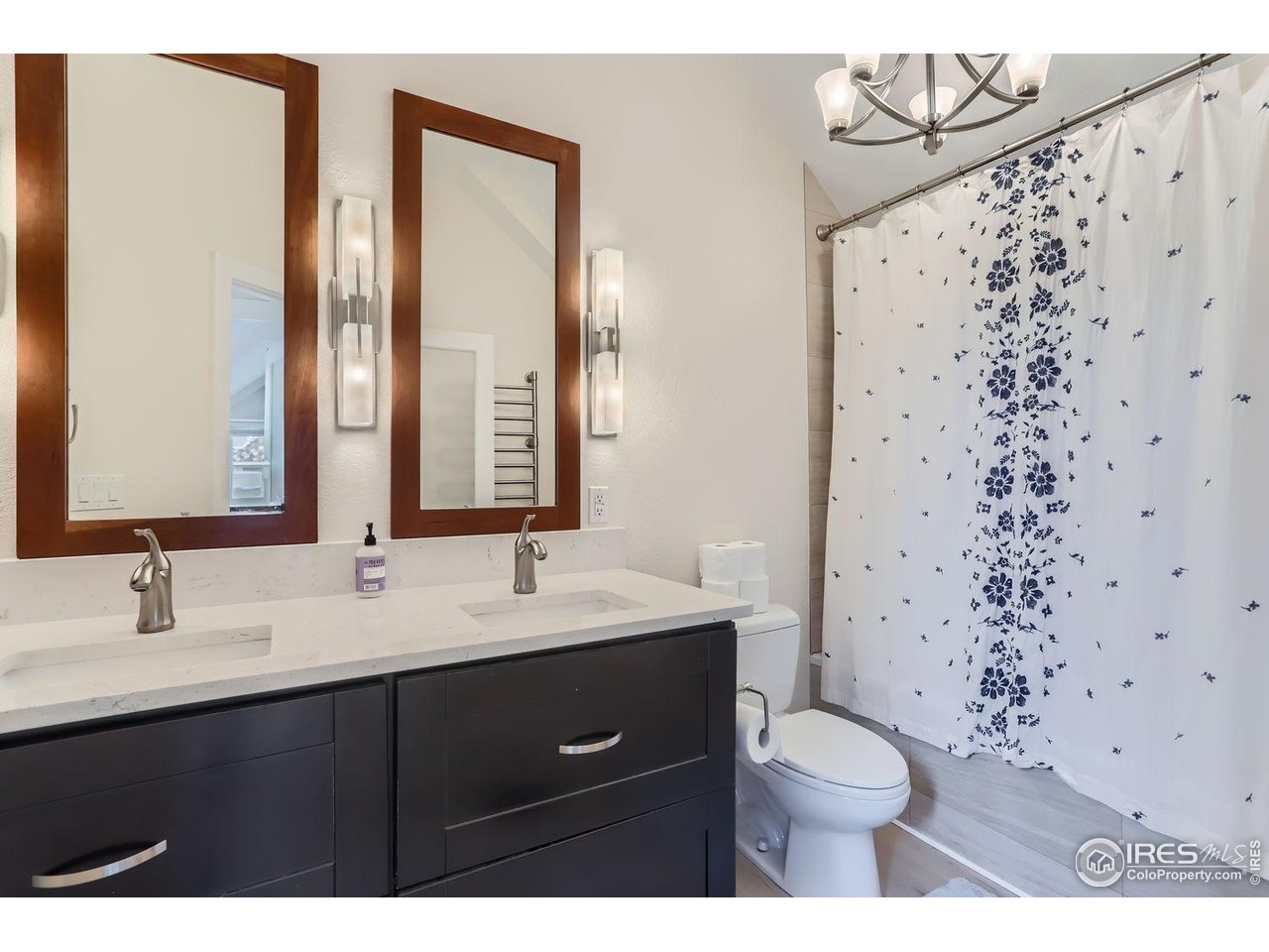620 Pearl Street, Unit E Boulder, CO 80302 - Photo 19 of 37 a bathroom with a sink a toilet a shower and a mirror